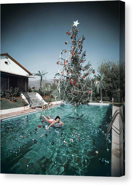 Christmas Swim Canvas Art Print by Slim Aarons