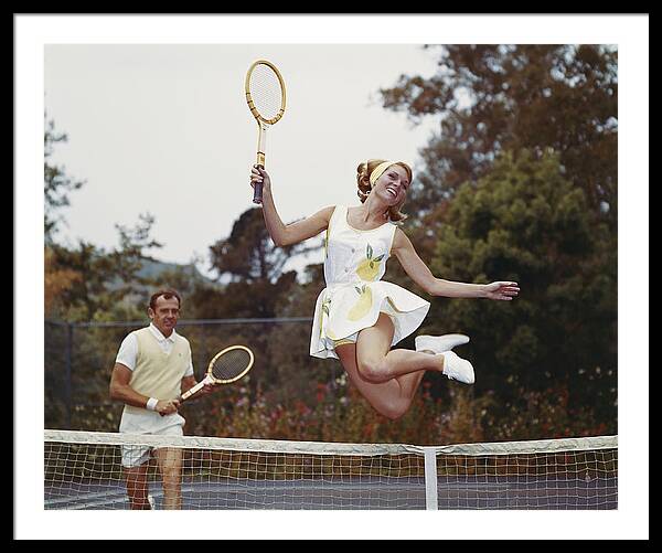 Couple On Tennis Court, Woman Jumping Framed Print